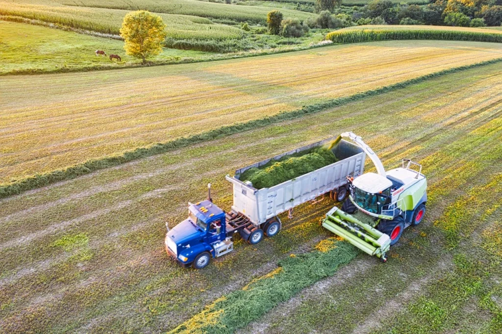 Aerial view of a tractor and harvester in a field during harvest in rural Minnesota.